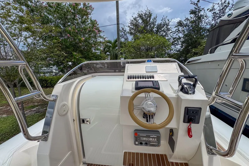 Slide: The Image of 2023 Tender Impertus 36 boat cockpit with steering wheel and control panel. - 30