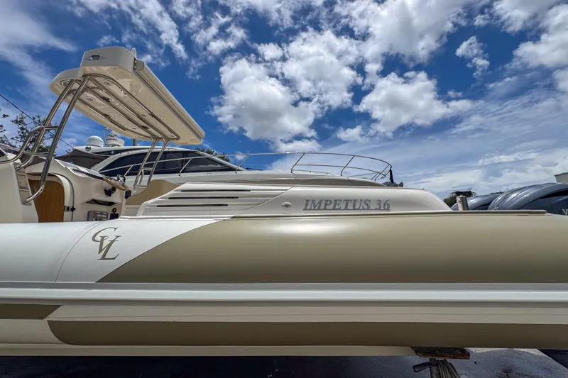 Slide: The Image of 2023 Tender Impertus 36 boat under a vibrant blue sky with clouds. - 35