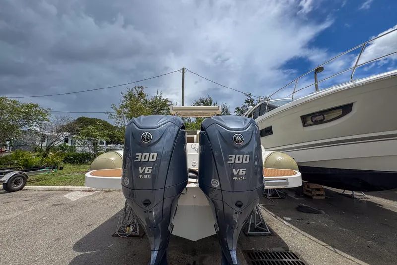 Slide: The Image of 2023 Tender Impertus 36 with dual 300 V6 outboard engines, parked outdoors. - 37