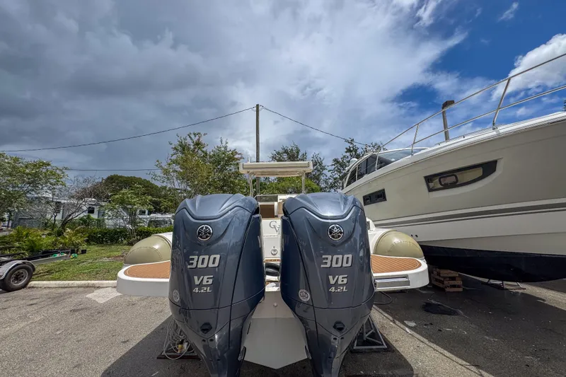 Slide: The Image of 2023 Tender Impertus 36 with dual 300 V6 outboard engines, parked outdoors. - 38