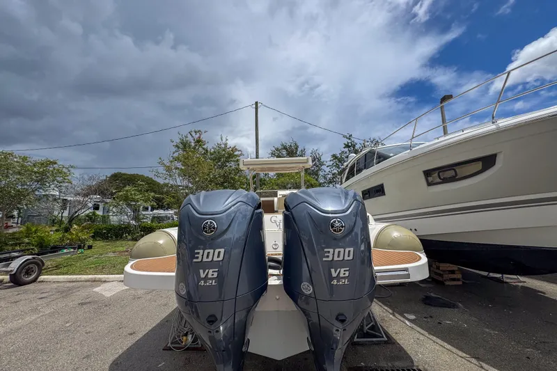 Slide: The Image of 2023 Tender Impertus 36 with dual 300 V6 outboard engines, parked outdoors. - 39