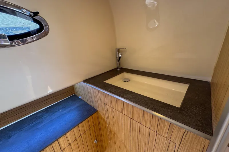 Slide: The Image of Modern bathroom interior of 2023 Tender Impertus 36 yacht with sleek sink and wooden cabinetry. - 42