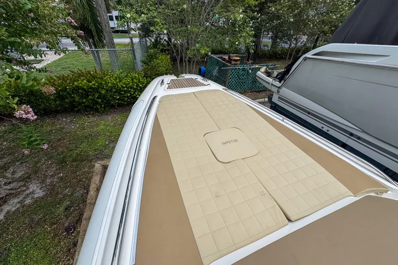 Slide: The Image of 2023 Tender Impertus 36 boat with beige deck, parked outdoors. - 44