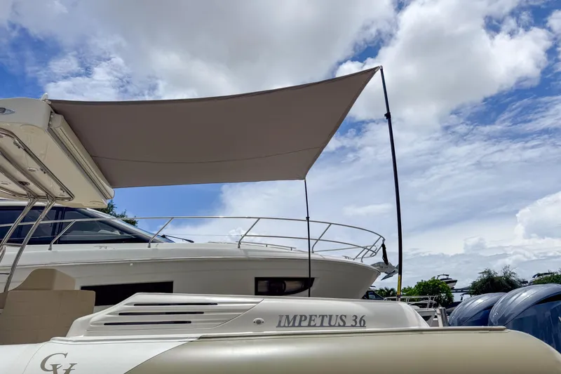 Slide: The Image of 2023 Tender Impertus 36 boat with canopy under a partly cloudy sky. - 7