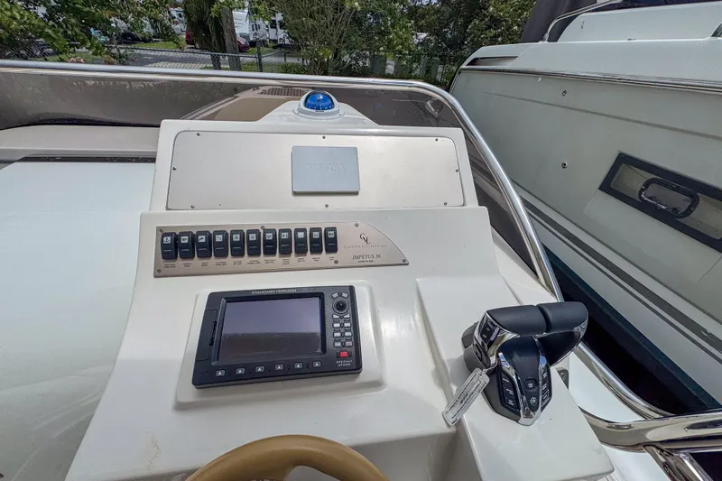 Slide: The Image of Control panel of 2023 Tender Impertus 36 boat with navigation system and throttle controls. - 8