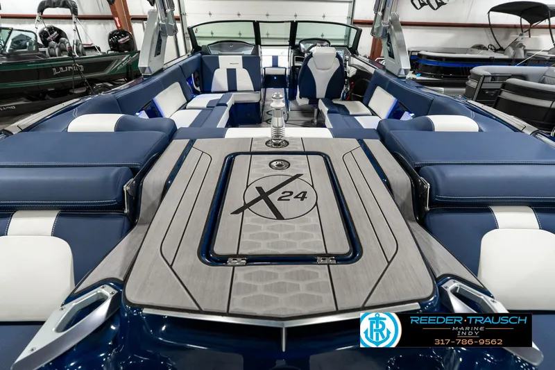 Slide: The Image of 2025 MasterCraft X24 boat interior with blue and white seating, showcasing luxury and style. - 16