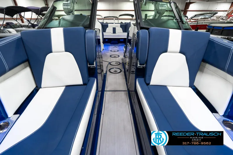 Slide: The Image of 2025 MasterCraft X24 interior with blue and white seating, showcasing luxury design. - 19