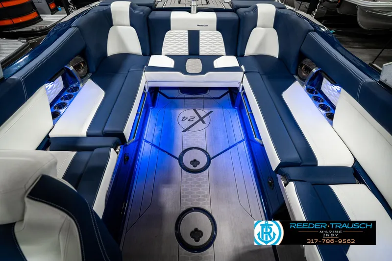 Slide: The Image of 2025 MasterCraft X24 boat interior with blue LED lighting and luxurious seating. - 30