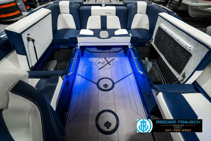 Slide: The Image of 2025 MasterCraft X24 boat interior with blue LED lighting and luxurious seating. - 31