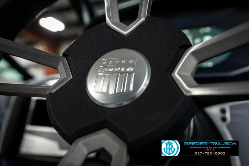 Slide: The Image of 2025 MasterCraft X24 steering wheel close-up with logo and Reeder-Trausch Marine contact details. - 40