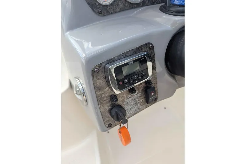 Slide: The Image of Dashboard of a 2013 Stingray 225cr boat with control panel and ignition key. - 11