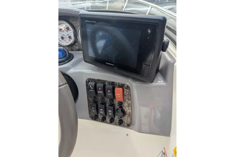 Slide: The Image of Dashboard of a 2013 Stingray 225cr boat with Garmin GPS and control switches. - 12