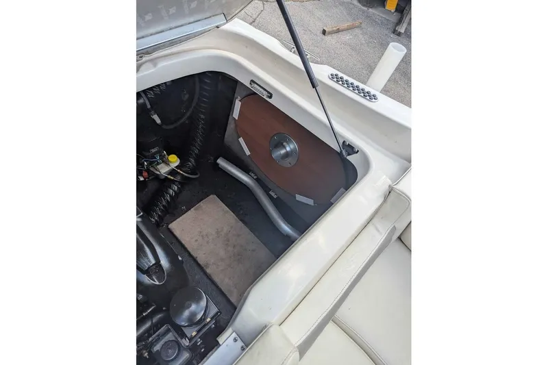 Slide: The Image of 2013 Stingray 225cr boat engine compartment with open hatch and visible components. - 13