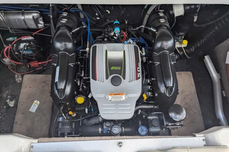 Slide: The Image of 2013 Stingray 225cr engine compartment with a 5.0 MPI motor, showcasing wiring and components. - 14