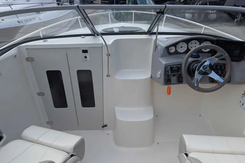 Slide: The Image of 2013 Stingray 225cr boat interior with steering wheel and dashboard controls. - 5