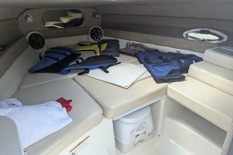 Slide: The Image of Interior of a 2013 Stingray 225cr boat with life jackets and seating area. - 6