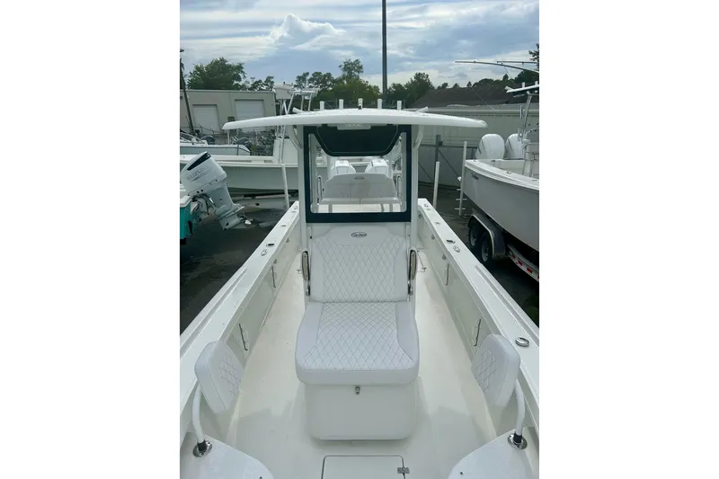 Slide: The Image of 2026 Pair Customs 27 Center Console boat on water near a drawbridge. - 10