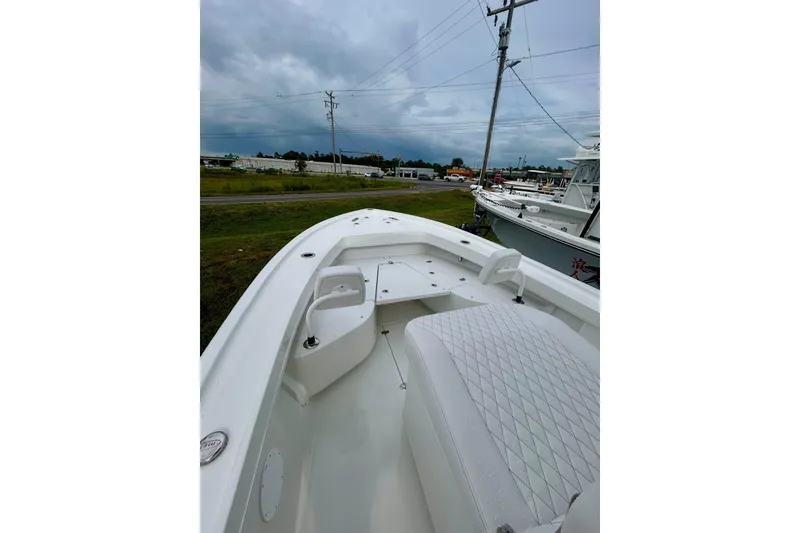 Slide: The Image of 2026 Pair Customs 27 Center Console boat on trailer, featuring dual outboard engines. - 12