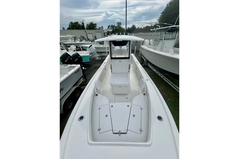 Slide: The Image of 2026 Pair Customs 27 Center Console boat with rear ladder on display. - 15