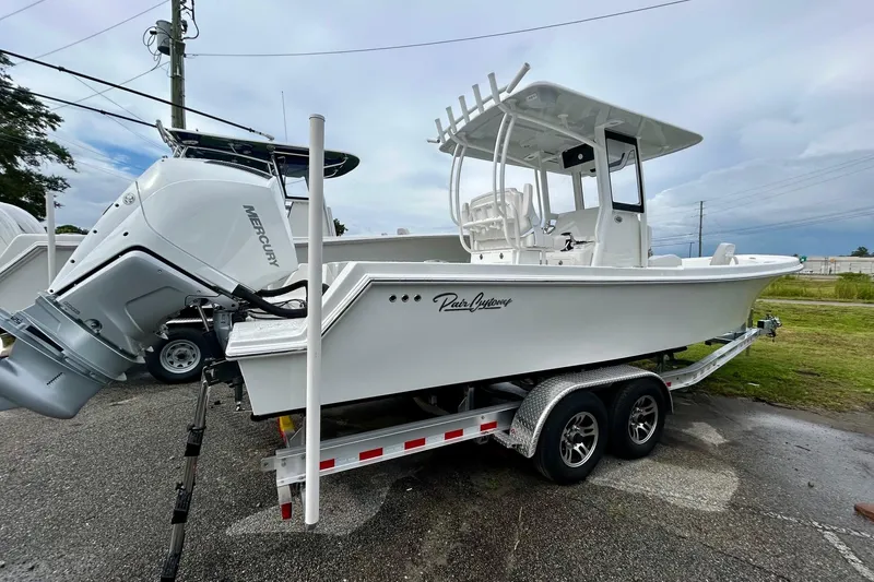 Slide: The Image of 2026 Pair Customs 27 Center Console boat on trailer with Mercury engine. - 20