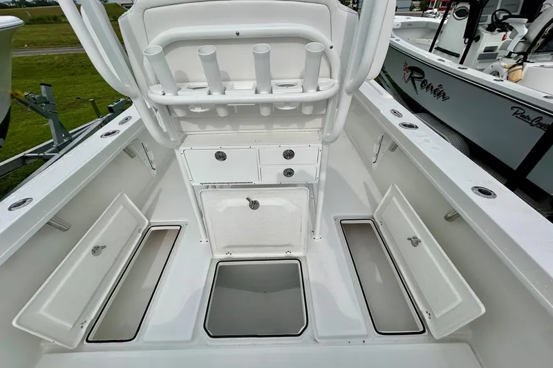 Slide: The Image of 2026 Pair Customs 27 Center Console boat on water near open drawbridge, under clear blue sky. - 6