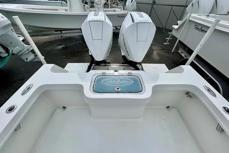 Slide: The Image of 2026 Pair Customs 27 Center Console boat with open storage compartment on deck. - 7