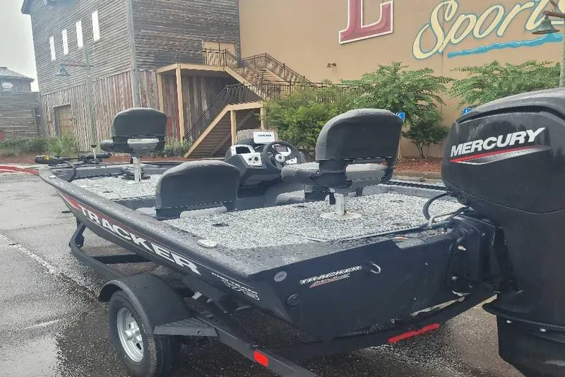 Slide: The Image of 2026 Tracker Pro Team 175 Crappie Edition boat with Mercury engine, parked outdoors. - 5