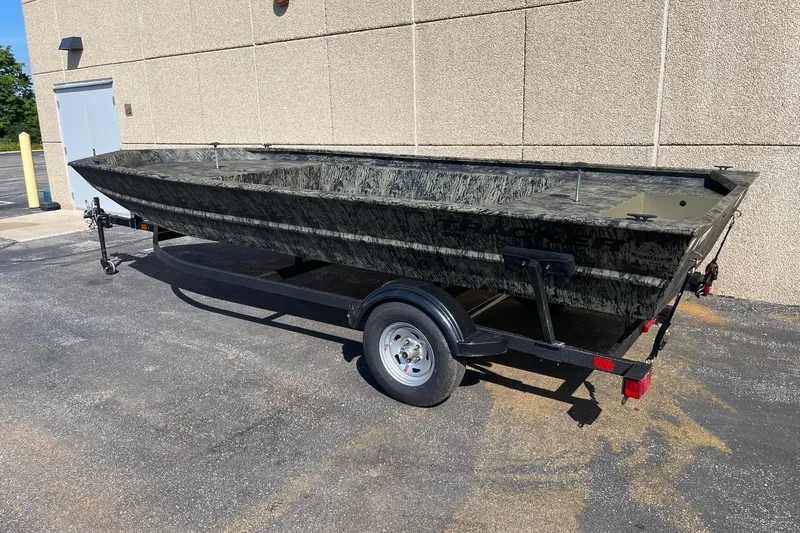 Slide: The Image of 2026 Tracker Grizzly 1860 Utility boat interior with camouflage pattern. - 2