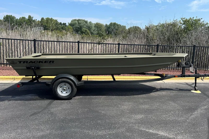 The Image of 2026 Tracker Grizzly 1754 Utility boat on trailer, parked outdoors. - 0