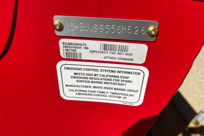 The Image of 2026 Tracker Pro Guide V-16 WT boat in red on a trailer, parked outdoors. - 0