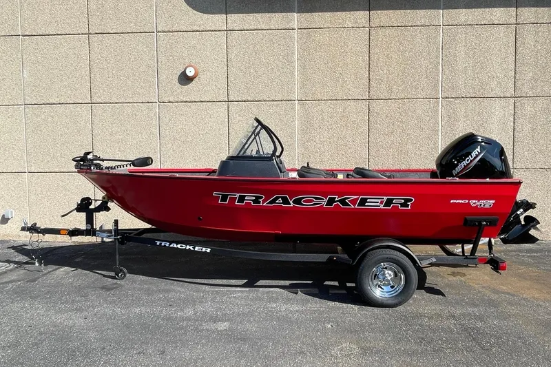 Slide: The Image of 2026 Tracker Pro Guide V-16 WT boat in vibrant red on a trailer. - 2