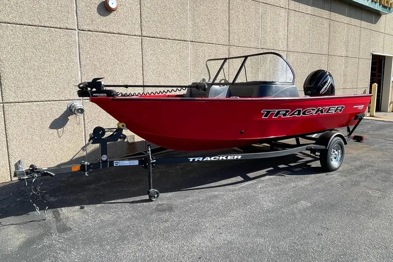 Slide: The Image of Interior of 2026 Tracker Pro Guide V-16 WT boat with three black seats. - 3