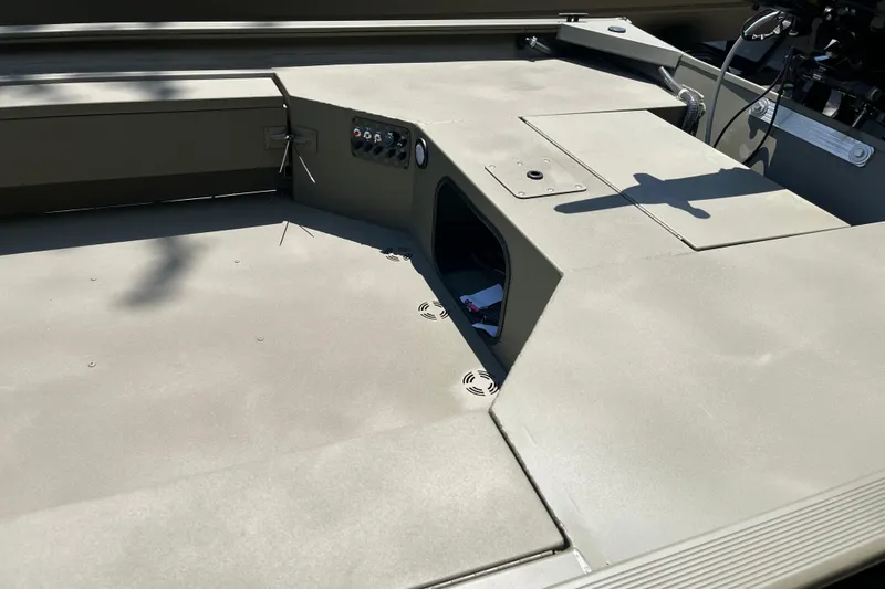 Slide: The Image of 2026 Tracker Grizzly 1654 T Sportsman boat interior with storage compartments and control panel. - 3