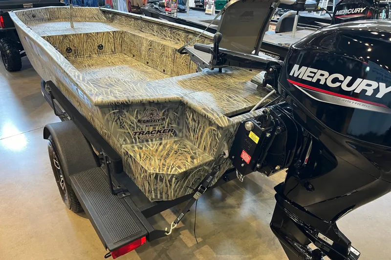 Slide: The Image of 2026 Tracker Grizzly 1654 T Sportsman boat with camo design and Mercury outboard motor. - 43