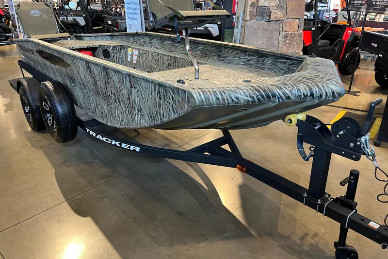 Slide: The Image of 2026 Tracker Grizzly 1654 T Sportsman boat on trailer in showroom. - 44