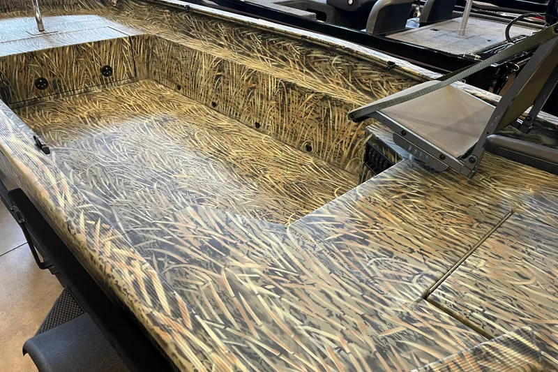 Slide: The Image of 2026 Tracker Grizzly 1654 T Sportsman boat interior with camouflage design. - 46