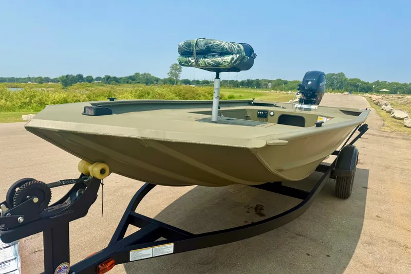 The Image of 2026 Tracker Grizzly 1654 T Sportsman boat on trailer, outdoors. - 0