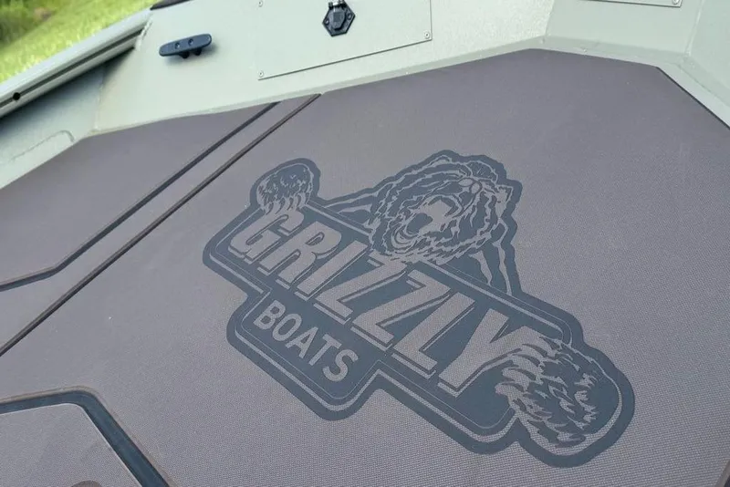 Slide: The Image of 2026 Tracker Grizzly 1860 CC boat deck with Grizzly Boats logo. - 5