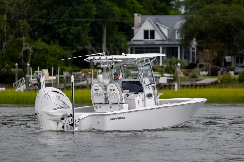Slide: The Image of 2020 Sportsman Masters 267OE Bay Boat cruising near waterfront homes. - 1