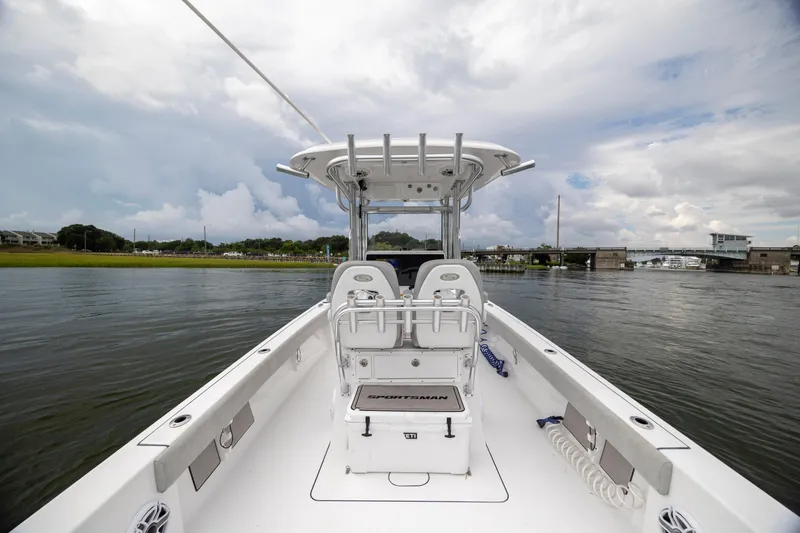 Slide: The Image of 2020 Sportsman Masters 267OE Bay Boat on calm water, cloudy sky background. - 11