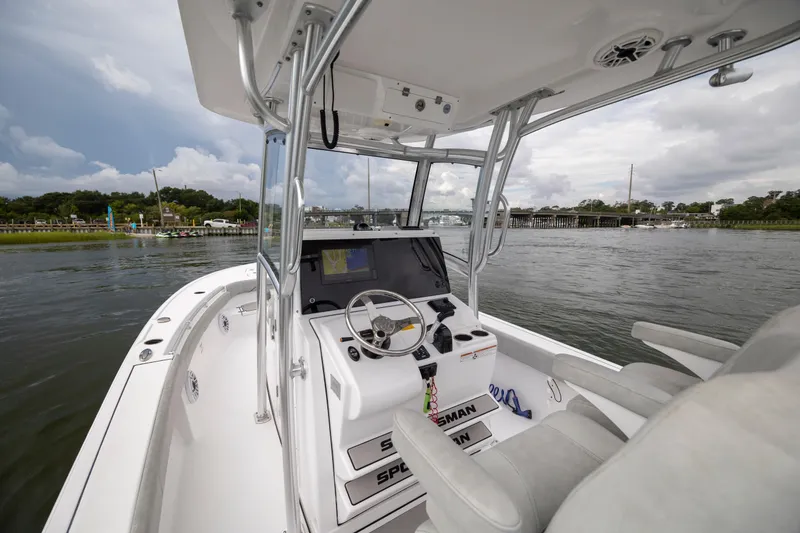Slide: The Image of 2020 Sportsman Masters 267OE Bay Boat interior with navigation system on calm waters. - 14