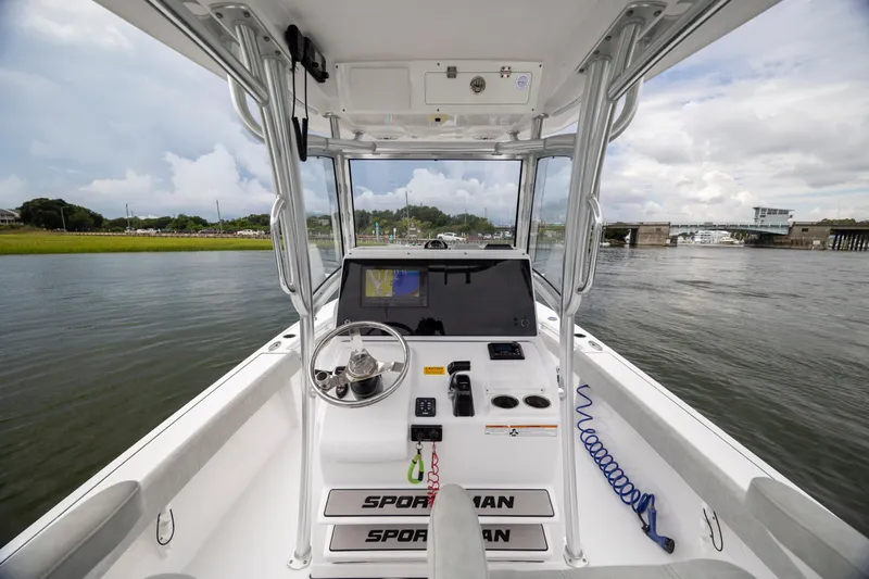Slide: The Image of 2020 Sportsman Masters 267OE Bay Boat interior with navigation system on calm waters. - 15