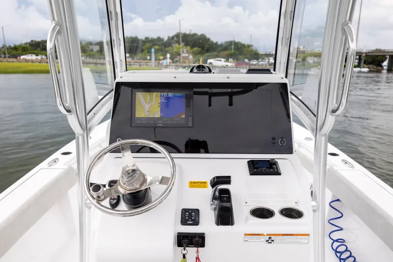 Slide: The Image of 2020 Sportsman Masters 267OE Bay Boat dashboard with navigation display and steering wheel. - 16