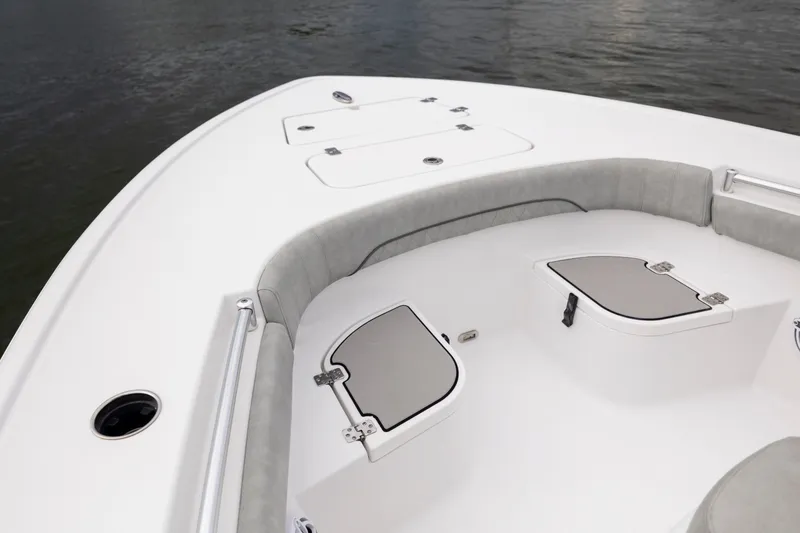 Slide: The Image of 2020 Sportsman Masters 267OE Bay Boat interior with cushioned seating and storage compartments. - 18