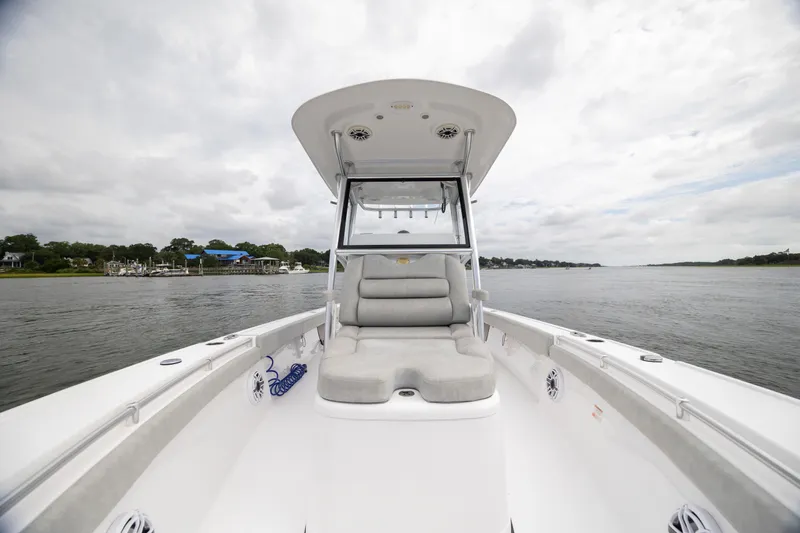 Slide: The Image of 2020 Sportsman Masters 267OE Bay Boat on calm water, featuring spacious seating and sleek design. - 20