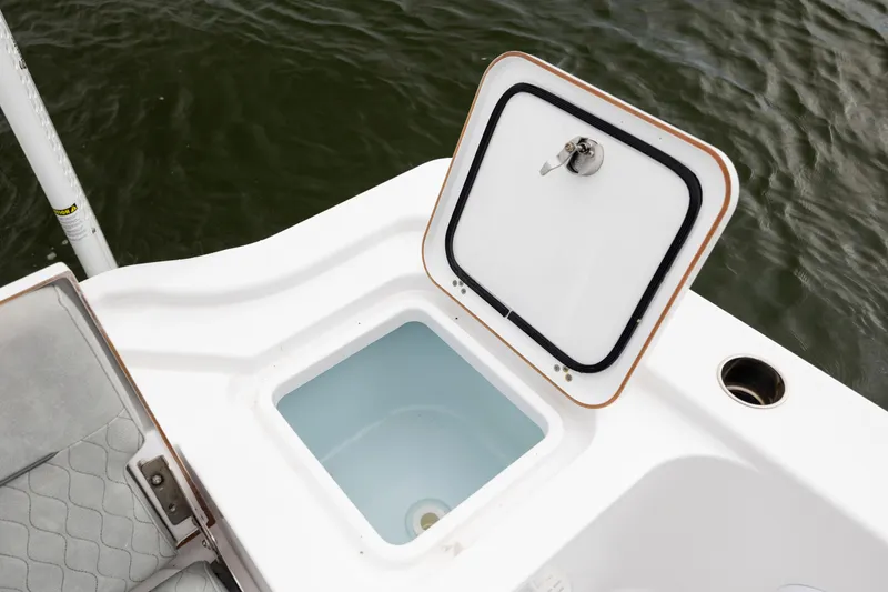 Slide: The Image of Open storage compartment on 2020 Sportsman Masters 267OE Bay Boat, near water. - 26