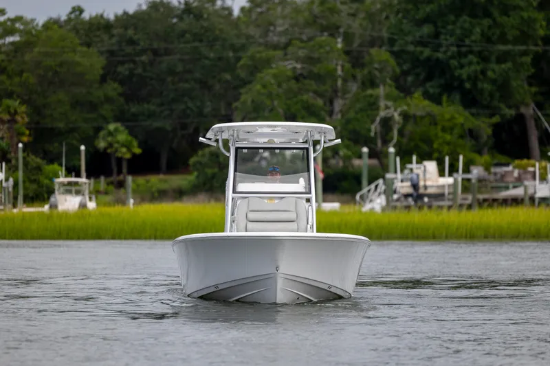 Slide: The Image of 2020 Sportsman Masters 267OE Bay Boat cruising on a calm river with lush greenery. - 3
