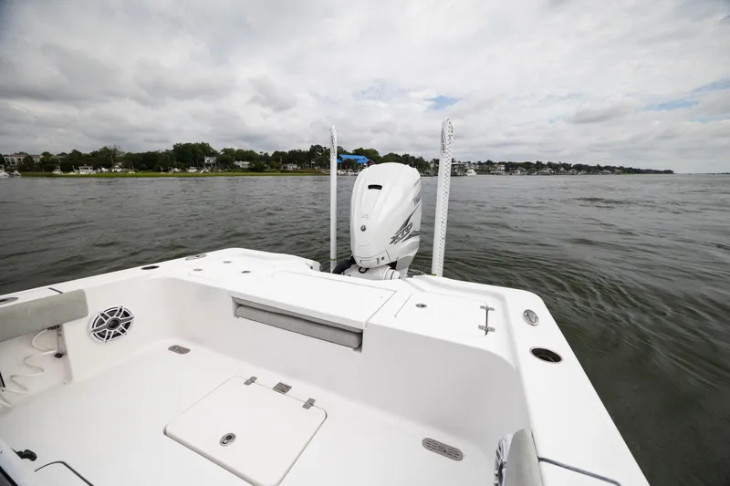 Slide: The Image of 2020 Sportsman Masters 267OE Bay Boat on calm waters, showcasing rear deck and motor. - 9
