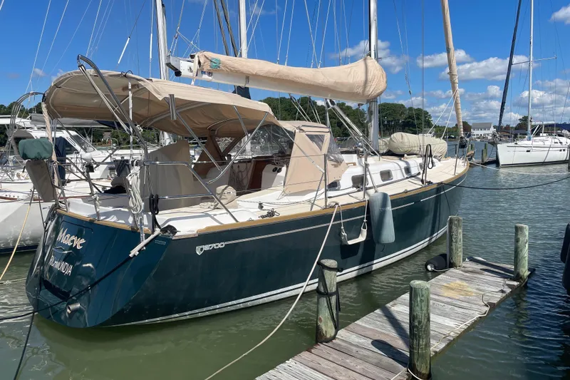 The Image of Sailboat Tartan 3700, 2004 model, docked at marina under clear blue sky. - 0