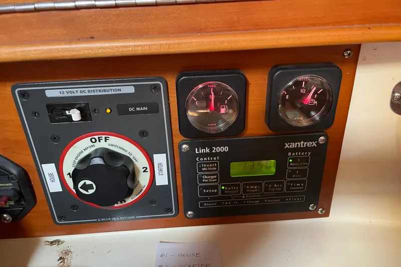 Slide: The Image of Control panel of a 2004 Tartan 3700 sailboat with gauges and switches. - 12